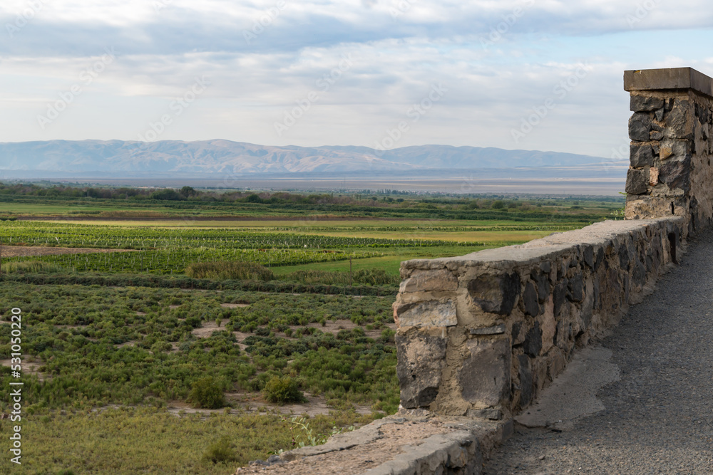 Fototapeta premium Part of the fortress wall and mountain view in Armenia.