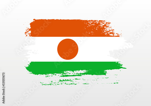 Modern style brush painted splash flag of Niger with solid background
