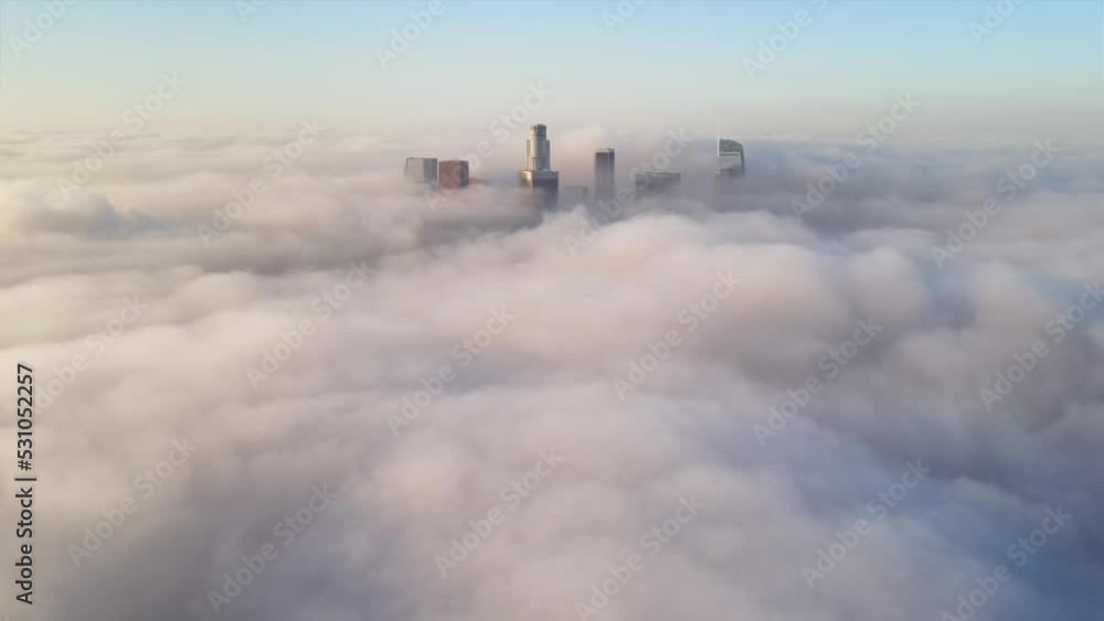 Aerial of the tall buildings of downtown Los Angeles poking through low clouds Aerial of the tall buildings of downtown Los Angeles poking through low clouds