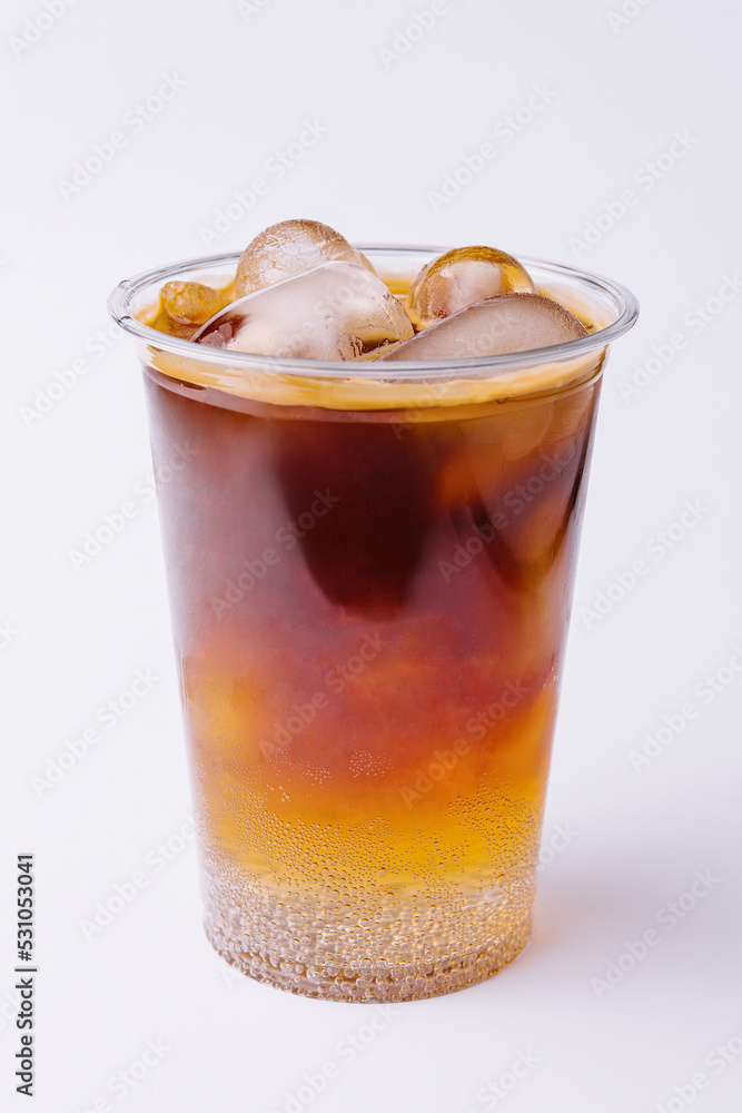 Cola with ice in plastic glass on white background Cola with ice in plastic glass on white background