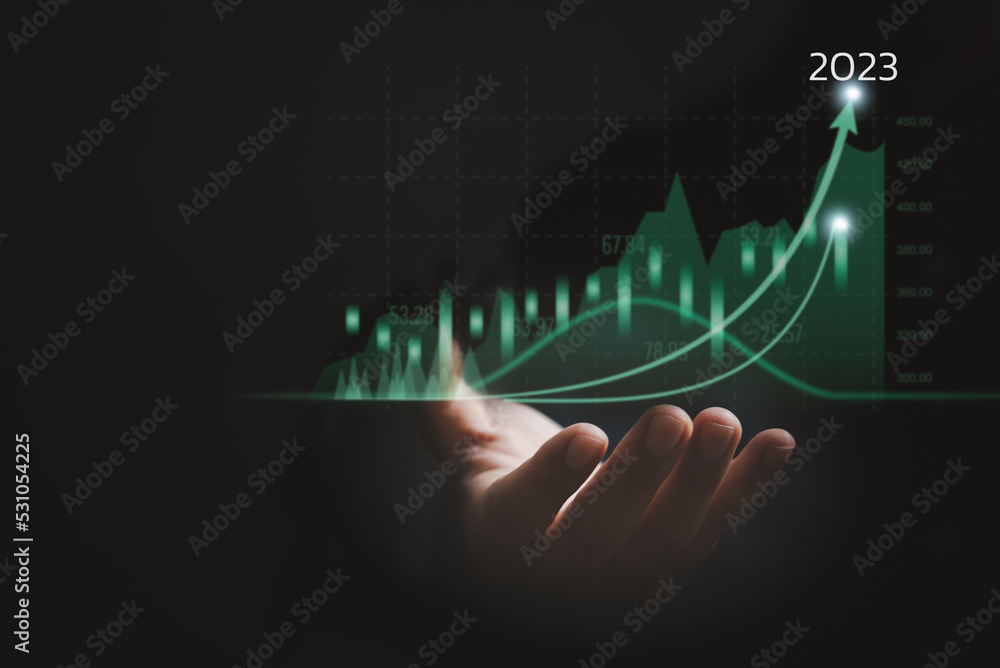 Businessman holding growth data chart arrow with 2023 budget diagram, Business graph corporate future Success development and motivation strategy Businessman holding growth data chart arrow with 2023 budget diagram, Business graph corporate future Success development and motivation strategy