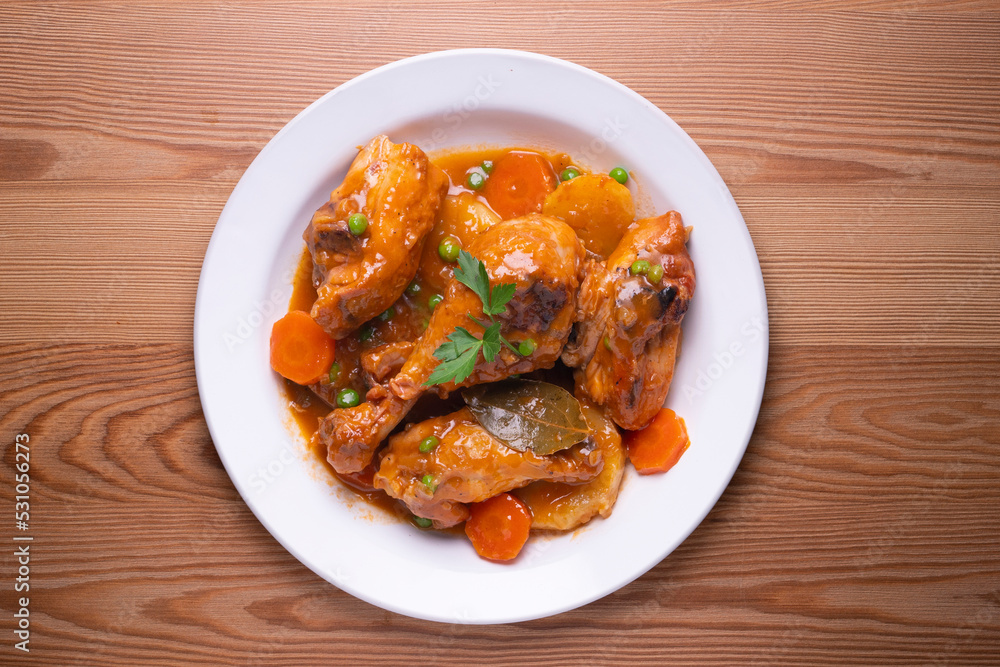 Chicken with vegetable sauce, carrots, peas and potato. Traditional Spanish dish recipe. Chicken with vegetable sauce, carrots, peas and potato. Traditional Spanish dish recipe.