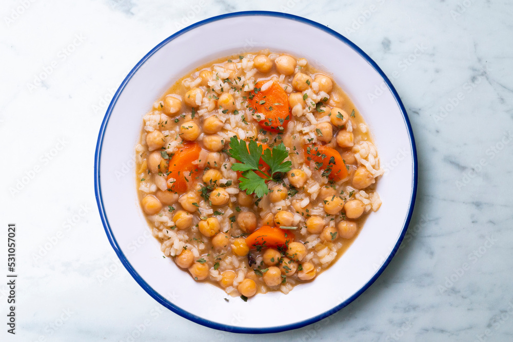 Chickpea stew with rice and carrots. Typical Spanish gastronomy dish. Chickpea stew with rice and carrots. Typical Spanish gastronomy dish.