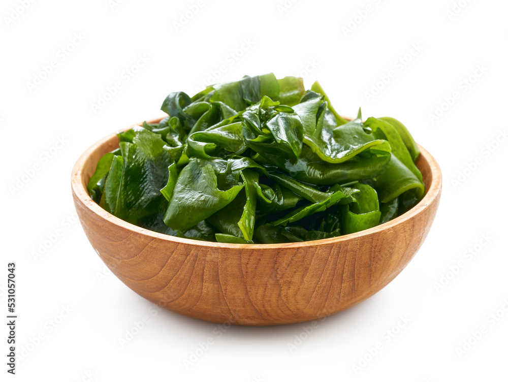 Laminaria or Kelp Seaweed in wood plate Isolated on White Background. fresh Laminaria or kelp Seaweed Isolated on White Background. konbu, alga Laminaria or Kelp Seaweed in wood plate Isolated on White Background. fresh Laminaria or kelp Seaweed Isolated on White Background. konbu, alga