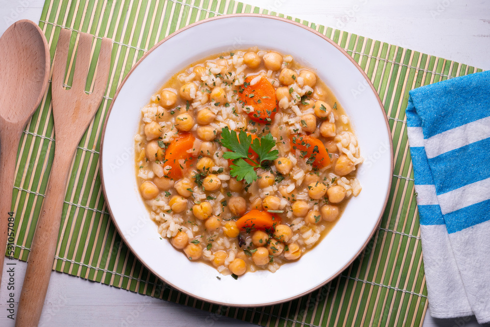 Chickpea stew with rice and carrots. Typical Spanish gastronomy dish. Chickpea stew with rice and carrots. Typical Spanish gastronomy dish.