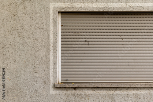 a window with closed roller shutter