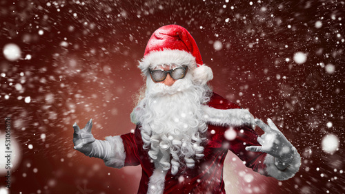 cool santa claus in sunglasses calls out discounts © Igor Link