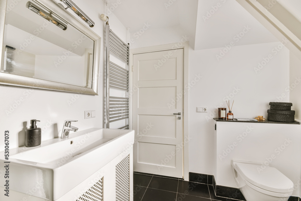Sink next to a mirror with white walls Sink next to a mirror with white walls