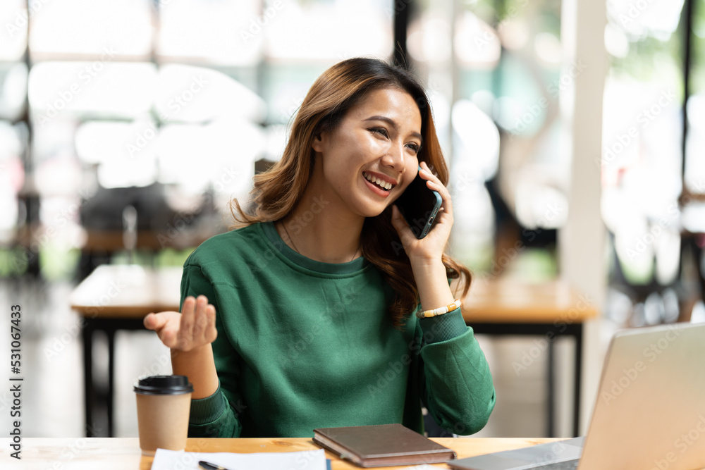 Asian businesswoman in formal suit in office happy and cheerful during using smartphone and working. Asian businesswoman in formal suit in office happy and cheerful during using smartphone and working.