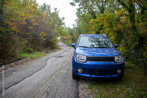 Blue car on a mountain path