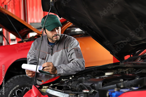 Car mechanic working with a Service checking car engine