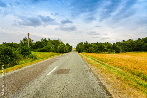 A country empty road along with nature,holiday and travel concept.Summer day.
