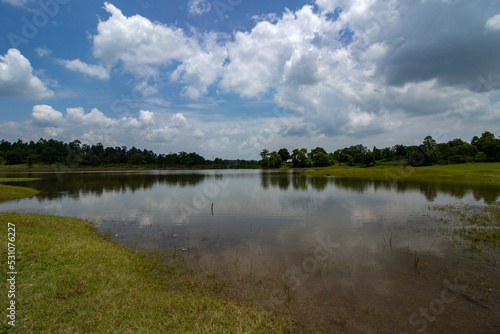 The beautiful Ketki Lake at Belpahari, Jhargram with reflection of blue sky and white clouds. Selective focus.