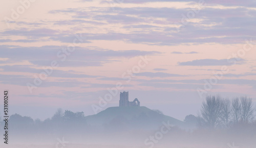 The ruined church of St. Michael on Burrow Mump, rising above the Somerset Levels at dawn on a frosty, misty morning, Burrowbridge, Somerset, England