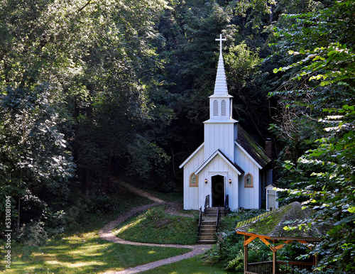 Old fashioned wooden country church in the forest