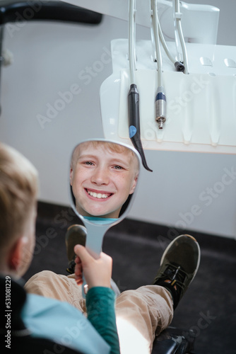 Young boy with mirror in dentistry 
