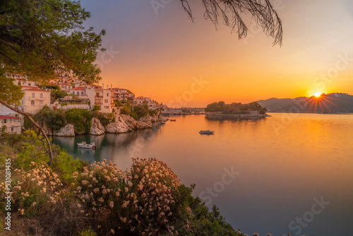 View of old town framed by trees at sunrise, Skiathos Town, Skiathos Island, Sporades Islands, Greek Islands, Greece photo