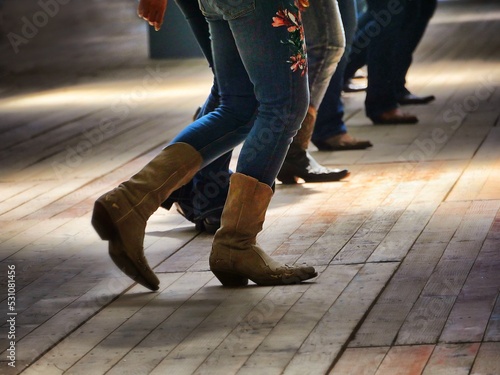 Legs close up of traditional western folk music dancers blur dynamism effect photo
