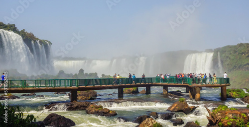 tourists on platform in waters of Iguacu river, at Iguacu falls, Argentina Brazil border