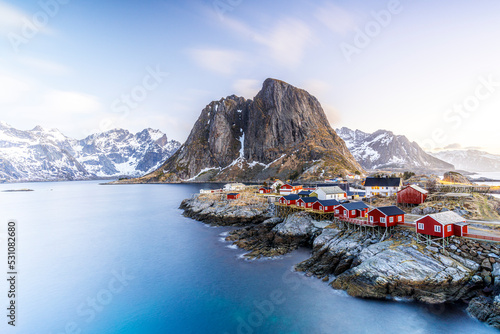 High angle view of traditional red Rorbu cabins in the fishing village of Hamnoy at dawn, Reine, Lofoten Islands, Norway photo