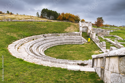 Woman enjoys the visit in the theatre of the Samnium archaeological site of Pietrabbondante, Isernia province, Molise, Italy