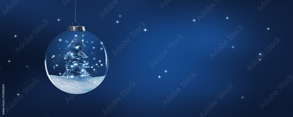 christmas ball decoration with shiny lights on snowy christmas tree at blue night, beautiful background with sparks and copy space for happy new year or xmas greeting card
