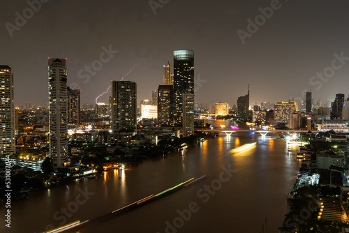 Cityscape background of Bangkok city, Thailand along the Chao Phraya River at night.