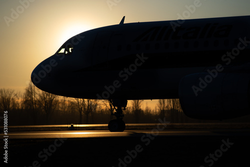 Obraz na plátně Airliner on runway ready to take off at sunset backlight - concept of air transp
