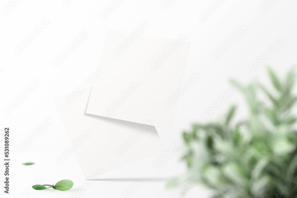 Clean minimal square flyer mockup floating on top table with plants Clean minimal square flyer mockup floating on top table with plants