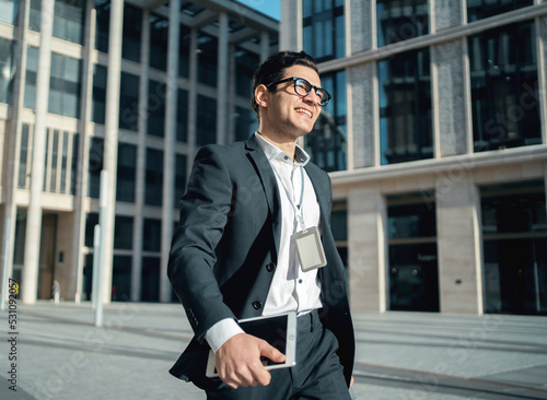An entrepreneur in a formal suit goes to the office to work