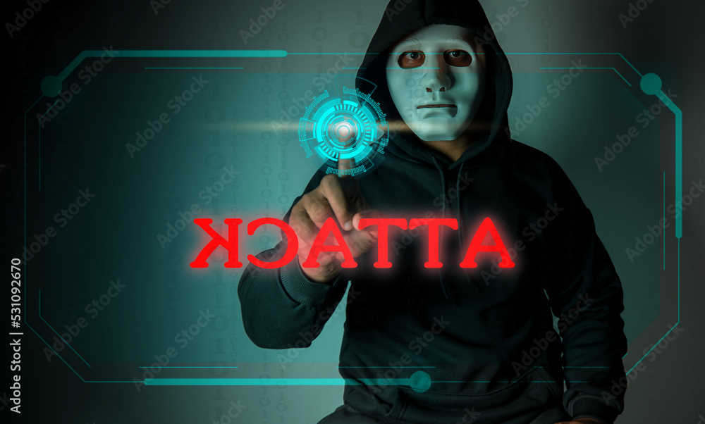 A hooded hacker is using his hands to press a button on a screen in the air to attack sensitive data.Hacking and malware concept. A hooded hacker is using his hands to press a button on a screen in the air to attack sensitive data.Hacking and malware concept.