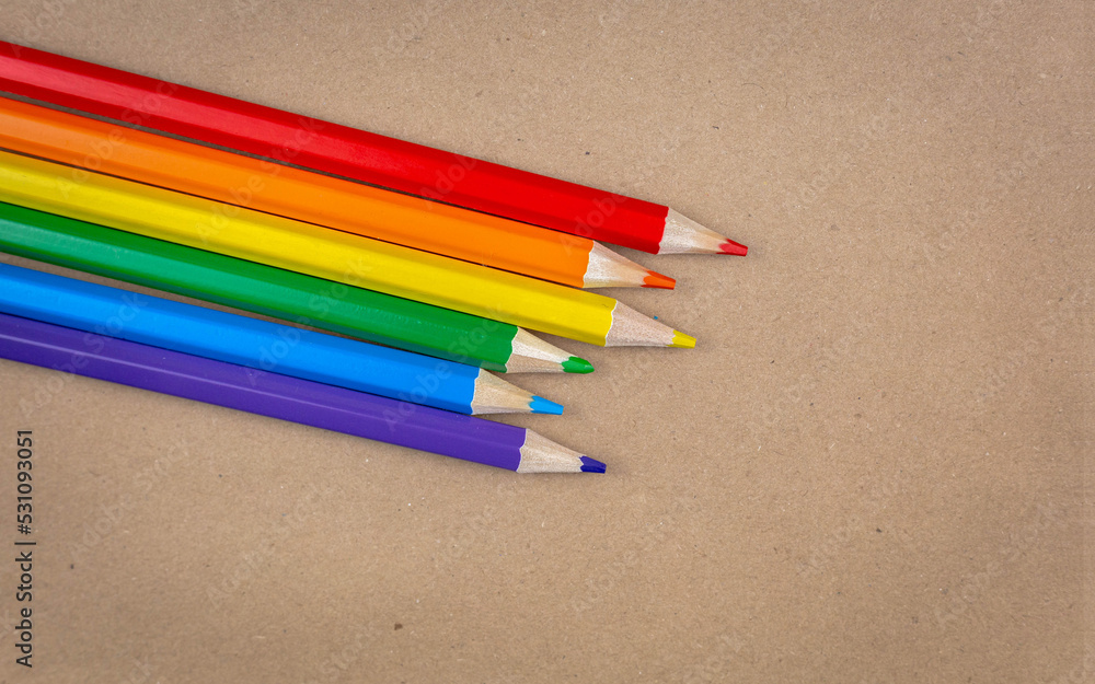 Colored pencils on a brown paper texture background Colored pencils on a brown paper texture background