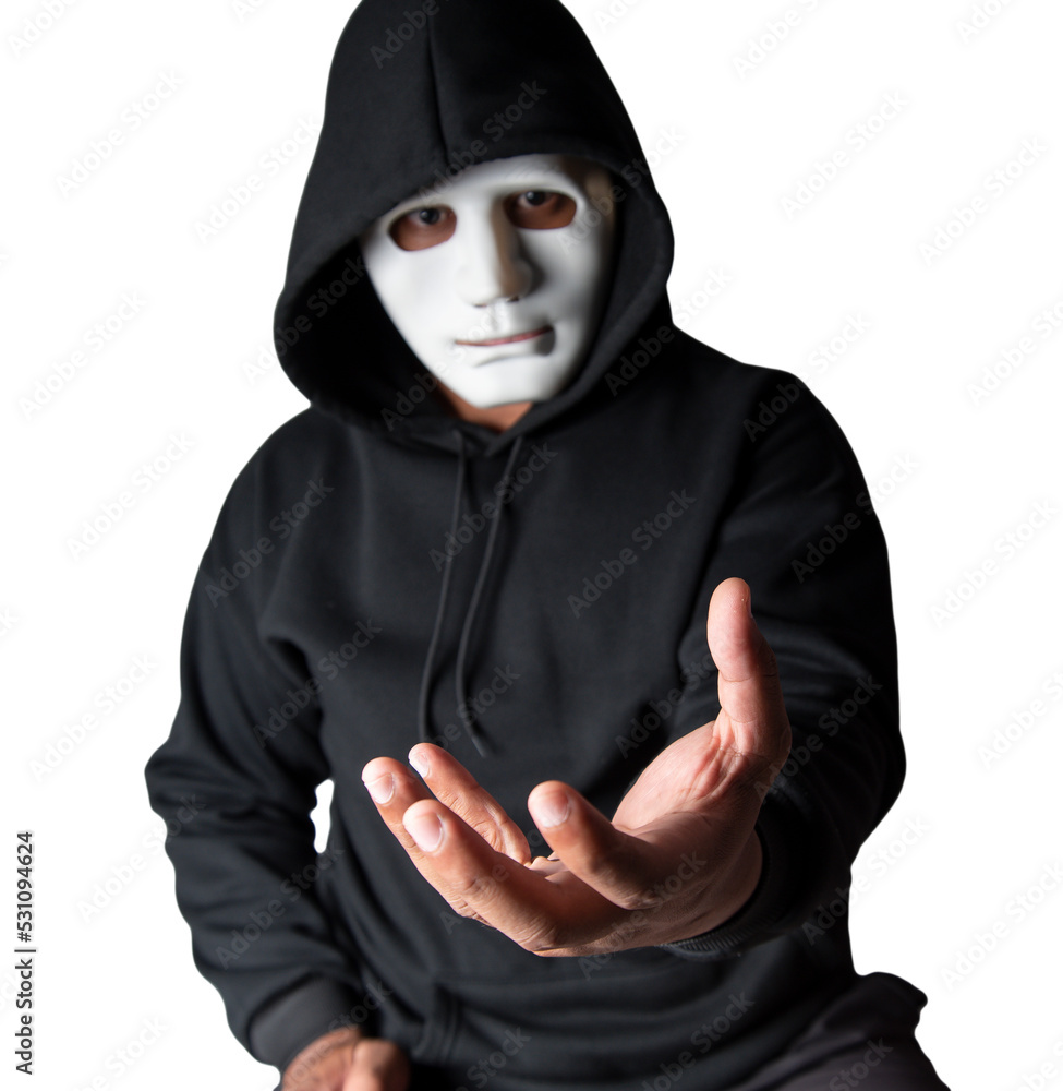 A portrait of an anonymous hacker wearing a mask and a black hoodie sitting with his head tilted and terrifying with clipping path. Hacking and malware concept. A portrait of an anonymous hacker wearing a mask and a black hoodie sitting with his head tilted and terrifying with clipping path. Hacking and malware concept.