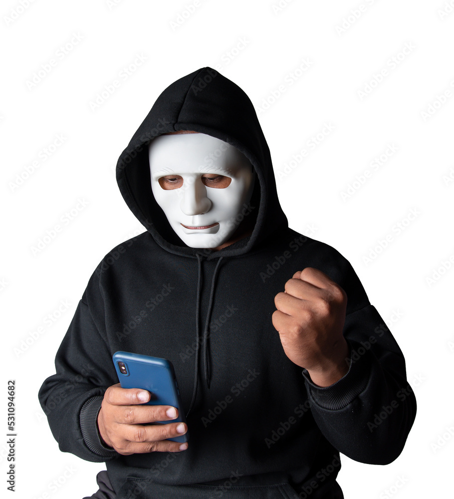 Anonymous masked hacker is using smartphones to penetrate financial data with clipping path, hacking and malware concept. Anonymous masked hacker is using smartphones to penetrate financial data with clipping path, hacking and malware concept.