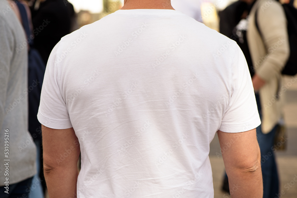Unrecognizable man dressed white t-shirt. Template for your design. Rear view. Closeup.