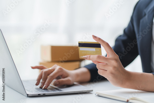 Happy asian Business woman pay online using mobile phone at the office.