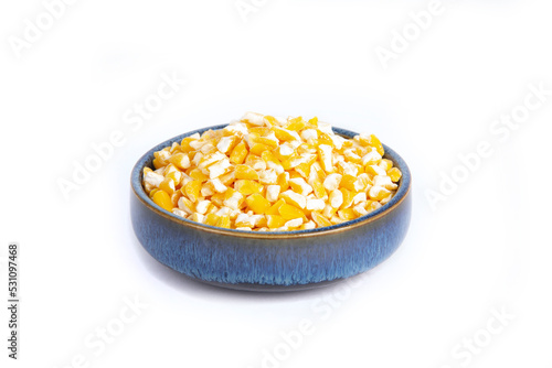 Yellow Hominy Corn in Blue Pottery Bowl Isolated on White photo