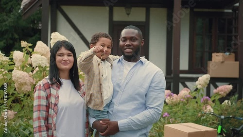 Portrait of a multi-ethnic family with keys who bought a new house. African dad, Caucasian mom, son.Multiracial Family,Mixed Race,Diverse People,Multiethnic Relations