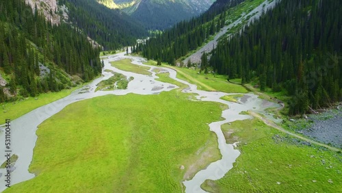 Aerial drone filmed beautiful mountains with a winding river flowing in the mountains of Kyrgyzstan, Karakol gorge near Issykul lake photo