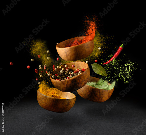 Fototapeta Naklejka Na Ścianę i Meble -  Spices and seasonings powder splash, explosion on black background