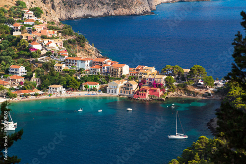 Close up top view at Asos village, Assos peninsula and fantastic blue Ionian Sea water. Aerial view, summer scenery of famous and extremely popular travel destination in Cephalonia, Greece, Europe.
