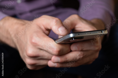A man hold in hands and using smartphone. Close up
