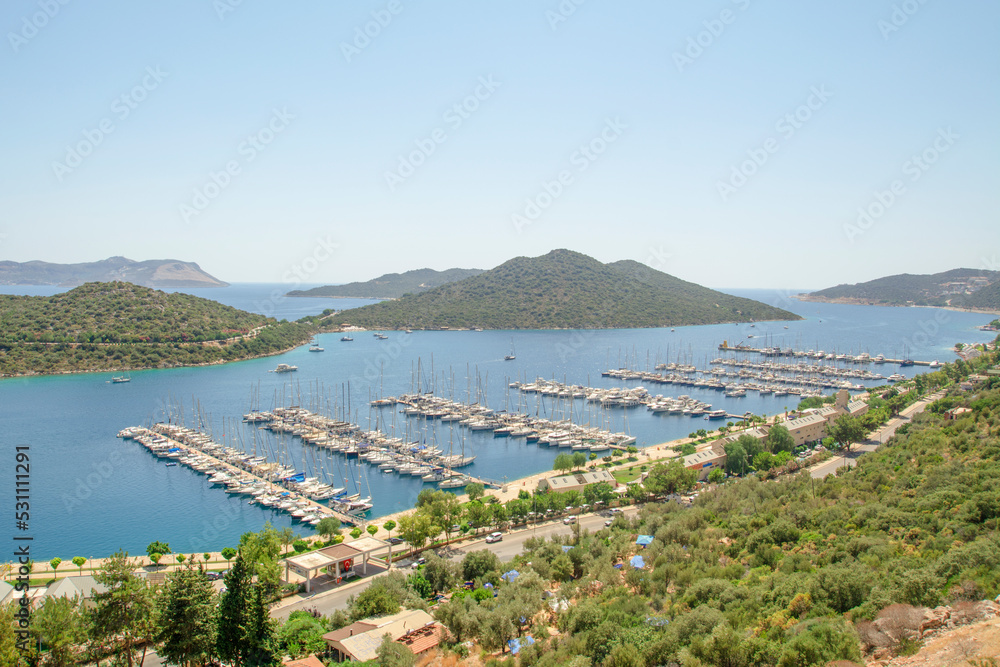 :  Charming view of seaside resort town of Kas in Turkey. Romantic harbour with yacht marina and mosque with minarets