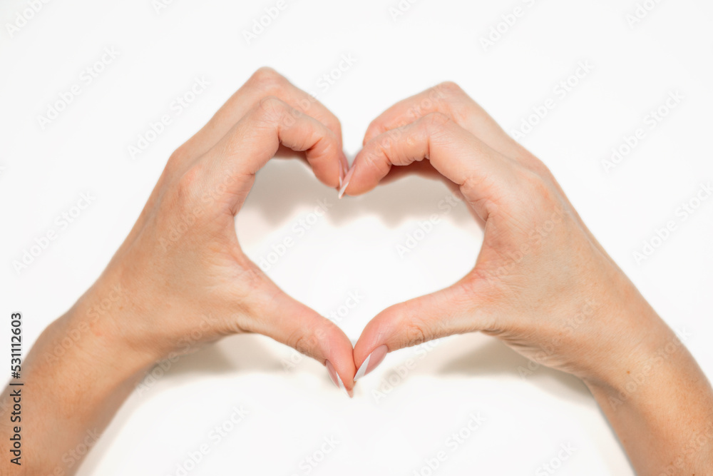 Female hands making sign Heart by fingers, isolated on white background. Beautiful hands of woman with copy space. Love concept on Valentine day. Female hands making sign Heart by fingers, isolated on white background. Beautiful hands of woman with copy space. Love concept on Valentine day.