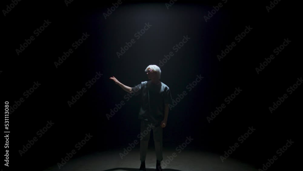 Man using vr glasses touching space in dark room. Focused cyber player swiping Man using vr glasses touching space in dark room. Focused cyber player swiping