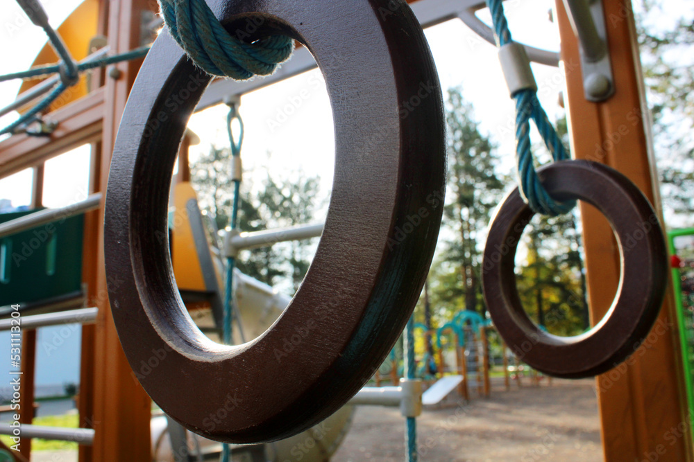 Gymnastic rings close-up on a children's outdoor playground. Healthy lifestyle concept. Gymnastic rings close-up on a children's outdoor playground. Healthy lifestyle concept.