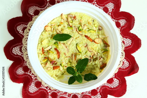 indian gujarati traditional sweet or mithai dudhi halwa or burfi pak made from bottle gourd (dudhi lauki) in dish with dry fruit garnish,top view photo