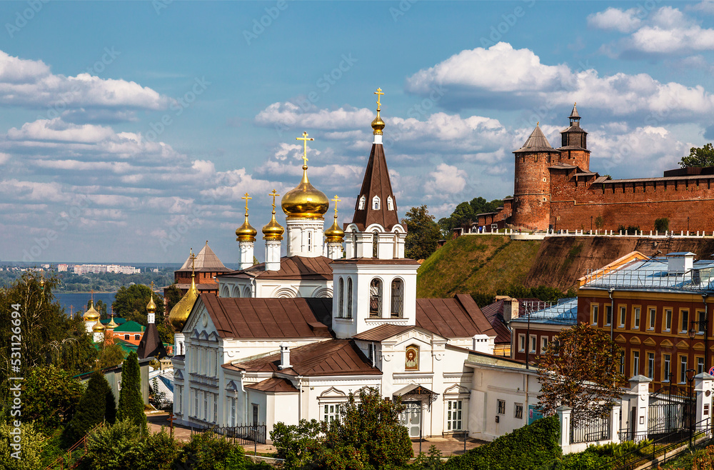 View of the Church of the Holy Prophet of God Elijah, the Kremlin wall with a tower and urban development. Nizhny Novgorod, Russia