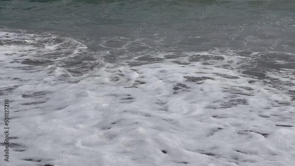 Low angle of the seashore with weak waves on the shore Low angle of the seashore with weak waves on the shore