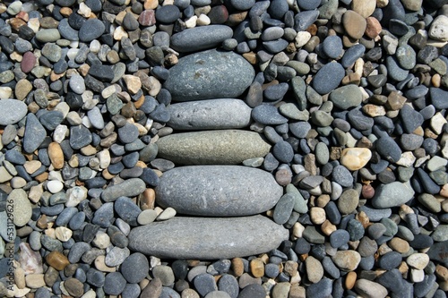 Photography Zen pyramid on a rocky beach.